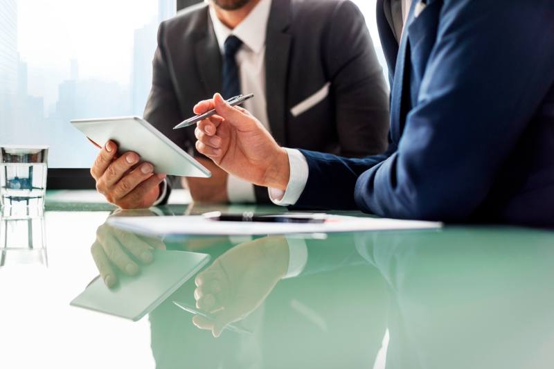 businessmen looking at tablet