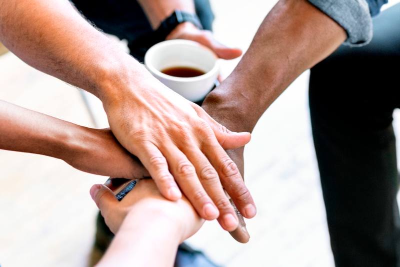 team stacking hands